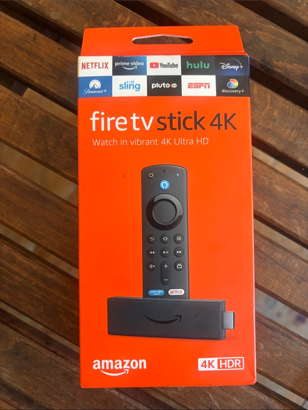 Amazon Fire TV Stick 4K in Bright Orange Box with Black Device